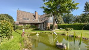 Teich mit Einfamilienhaus